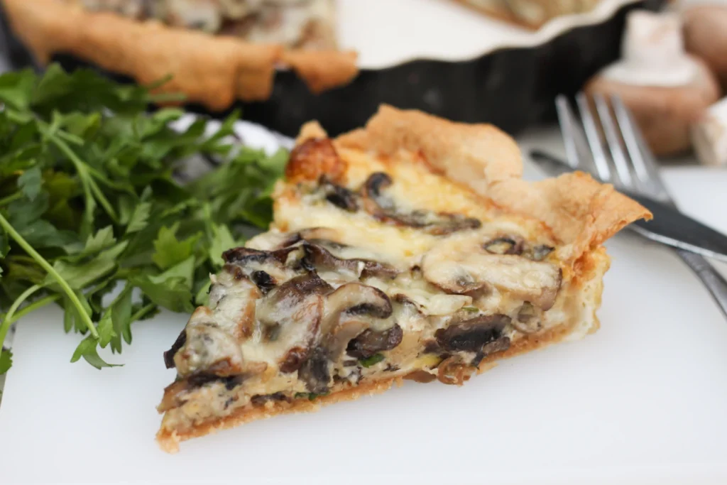 Chestnut Mushroom and Gruyère Tart. A flaky puff pastry tart topped with caramelized onions, deeply seared chestnut mushrooms, fresh thyme and a generous melt of nutty Gruyère cheese.
