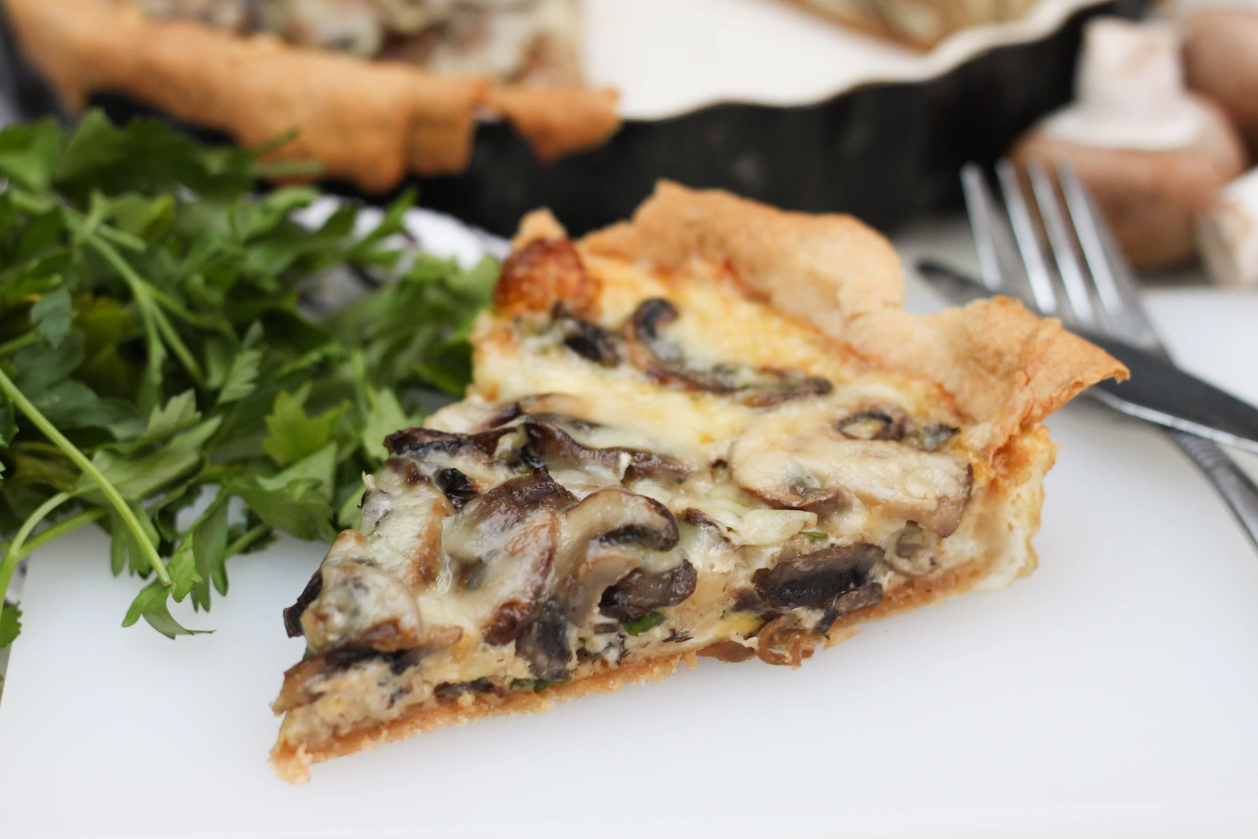 Chestnut Mushroom and Gruyère Tart. A flaky puff pastry tart topped with caramelized onions, deeply seared chestnut mushrooms, fresh thyme and a generous melt of nutty Gruyère cheese.