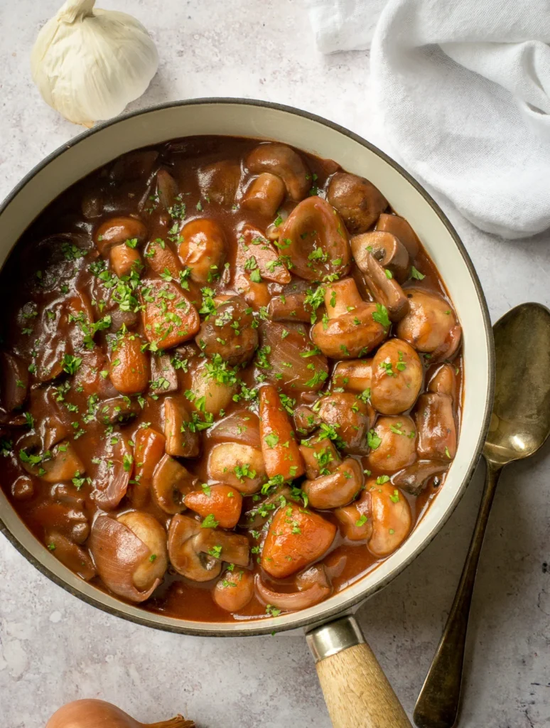 chestnut mushroom bourguignon:mushroom stew in a white bowl